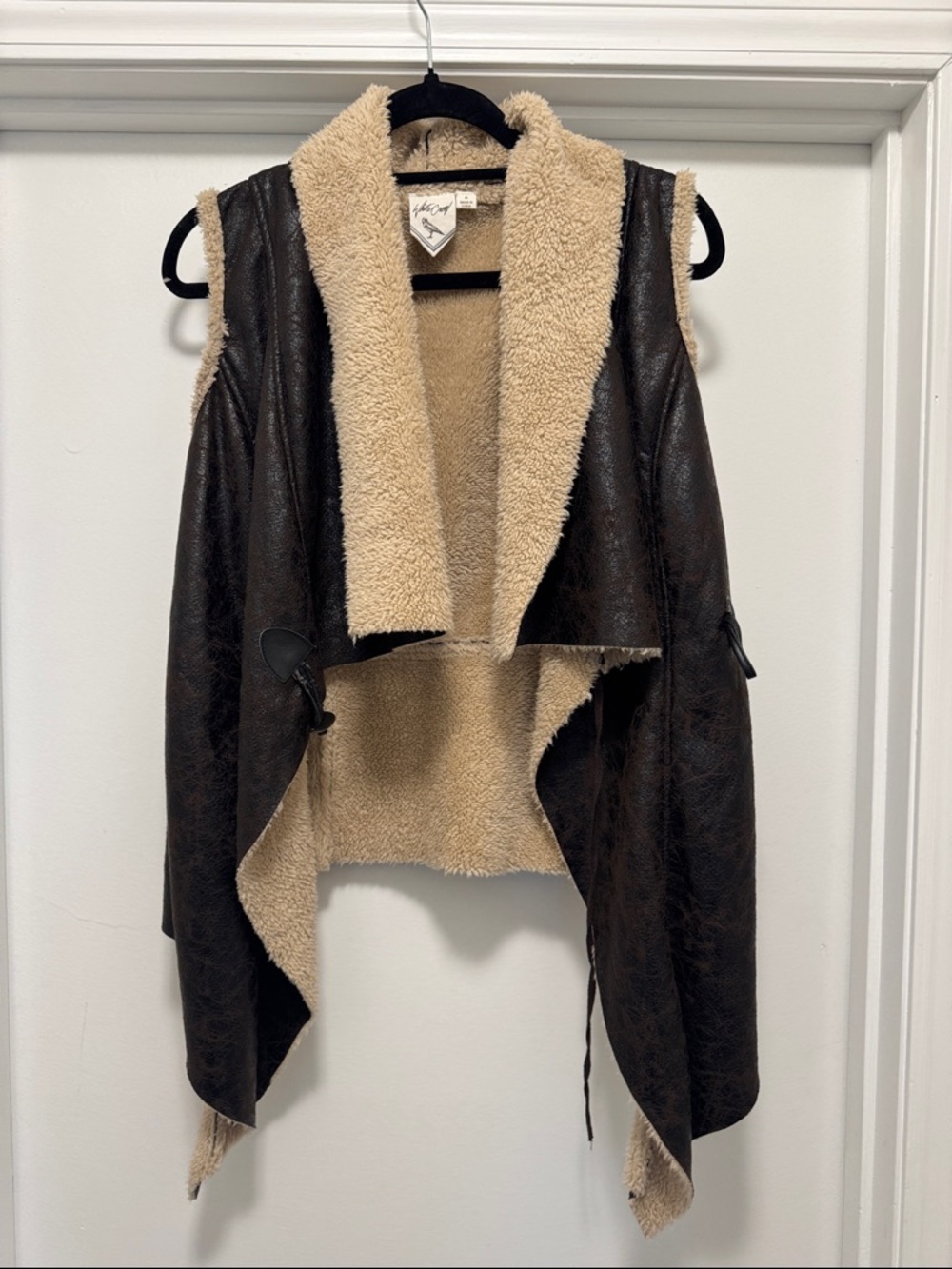 White Crow. Faux leather vest with beige lining. Like new